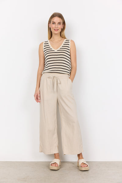 Soya Concept Ina 12-C Trousers in Sand Woman wearing a striped tank top and beige wide-leg pants against a white background