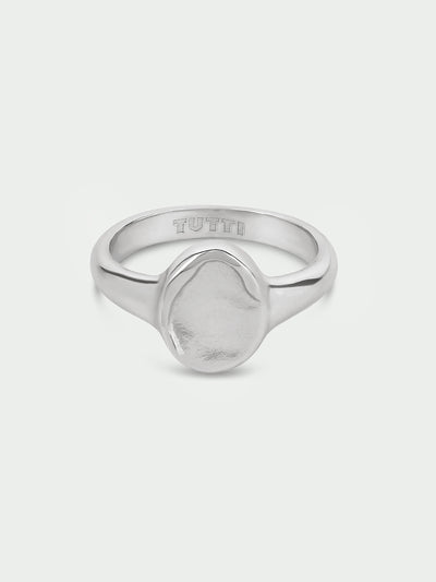Tutti & Co Aster Pinky Ring in Silver A silver signet ring with a textured, organic-shaped face and the brand name 'TUTTI' engraved inside the band, shown on a light gray background.