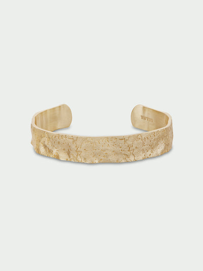 Tutti & Co Solstice Bangle in Gold Gold bracelet on a light beige background