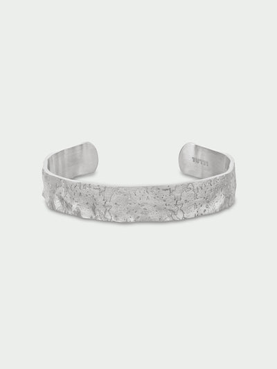 Tutti & Co Solstice Bangle in Silver A textured silver cuff bracelet with a hammered, organic surface finish, displayed on a light gray background.