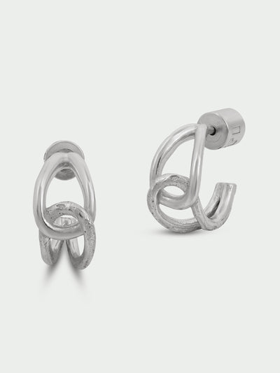 Tutti & Co Alder Earrings in Silver Pair of silver hoop earrings on a light gray background