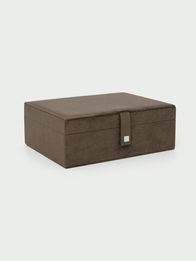 Tutti & Co Ritual Large Suede Jewellery Box A rectangular brown storage box with a textured fabric finish and a small silver metal accent on the front closure strap, shown on a light gray background.