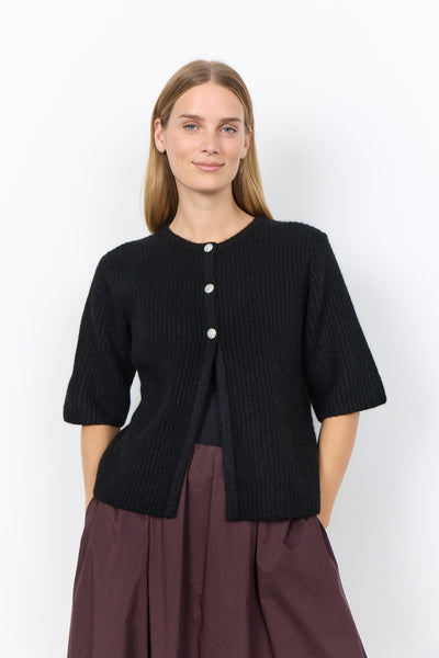 Soya Concept Herla 5 Cardigan in Black 500197 A woman modeling a black ribbed short-sleeve cardigan with three white buttons, paired with a dark brown skirt, against a plain white studio background.
