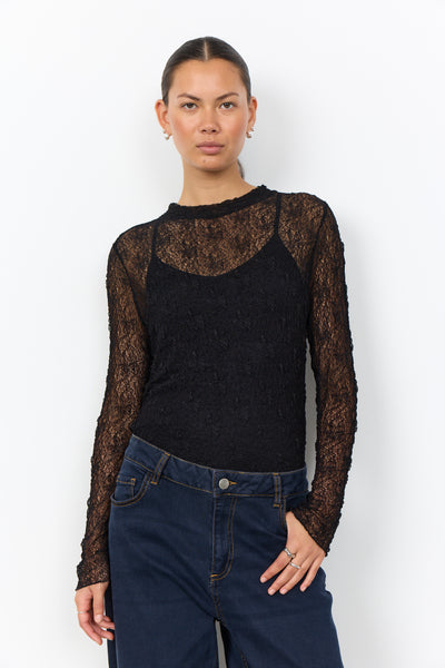 Soya Concept Jabina 1 Blouse in Black 500313 A woman modeling a black long-sleeve knit top with sheer lace sleeves and a textured knit body, paired with dark blue jeans, against a plain white background.