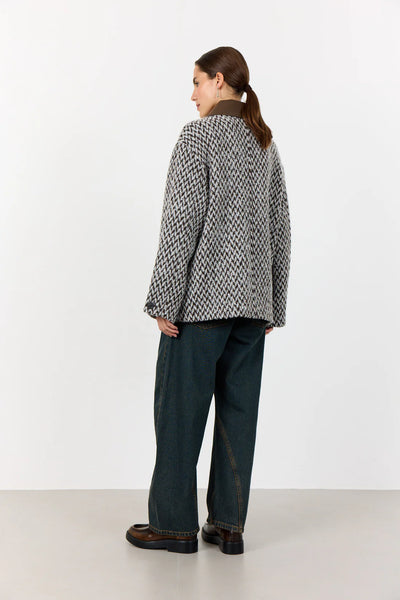 Levete Room Mai 1 Jacket in Coffee Combi Person wearing a patterned jacket and dark pants on a white background