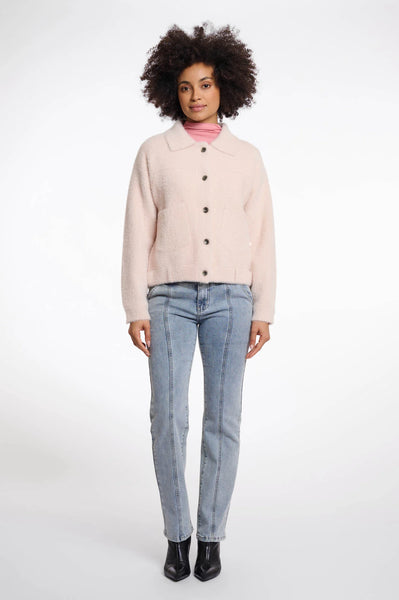 Rino & Pelle Bubbly Boxy Jacket in Pale Woman wearing a light pink jacket and blue jeans on a white background