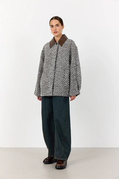 Levete Room Mai 1 Jacket in Coffee Combi Person wearing a patterned coat with a brown collar and dark pants on a white background