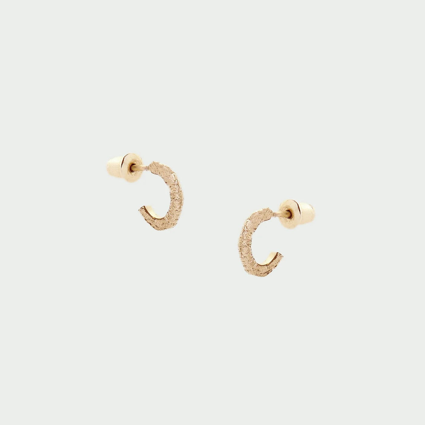 Tutti Aurora Earring in Gold Gold hoop earrings on a light gray background