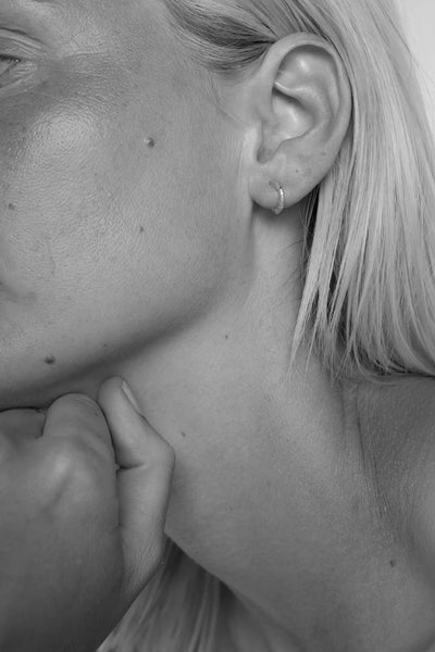 Tutti Aurora Earring in Silver Close-up of a person's ear with a visible earring