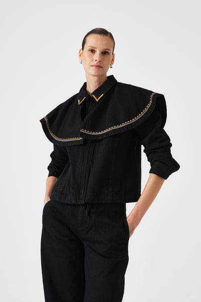 Seventy + Mochi Fara Jacket in Black WFAR0101 Person wearing a black outfit with gold trim on a white background