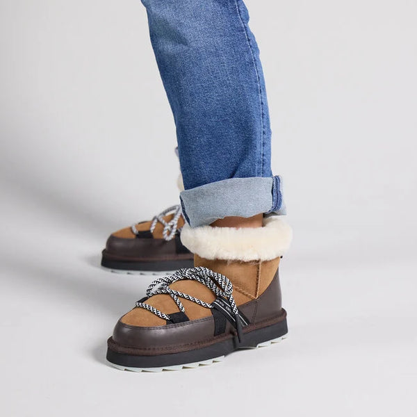 Emu Australia Blurred Micro in Chestnut W13129 Brown winter boots with white fur lining worn with blue jeans on a light gray background