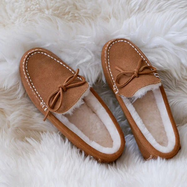 Emu Australia Sandrine in Chestnut W13211 Pair of brown slippers with white fur lining on a fluffy white surface