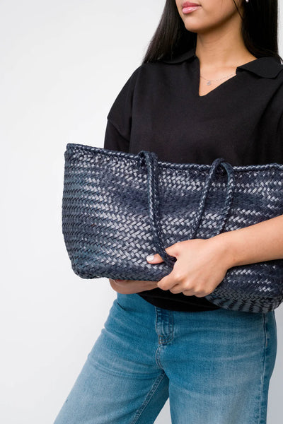 Ellyla Amora Woven Shoulder Bag in Dark Blue Person holding a dark blue woven handbag against a plain background