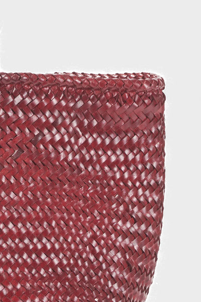 Ellyla Amora Woven Shoulder Bag in Burgundy Close-up of a woven red basket on a white background