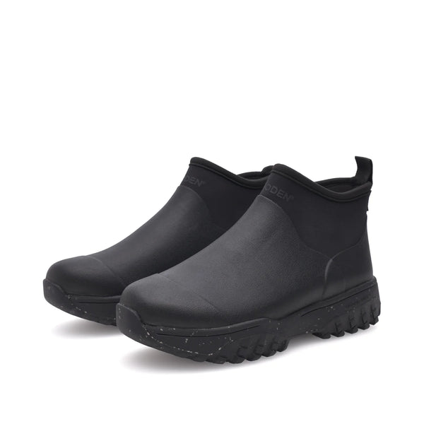 Woden Irene Waterproof Boot in Black Pair of black rubber boots on a white background