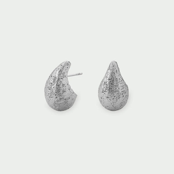 Tutti Small Dome Earrings in Silver Pair of silver teardrop-shaped earrings on a light gray background