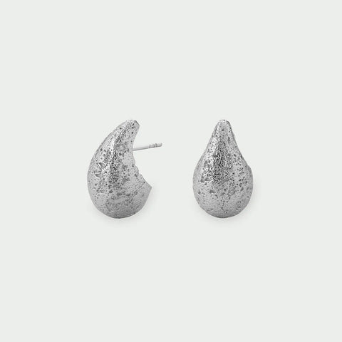Tutti Small Dome Earrings in Silver Pair of silver teardrop-shaped earrings on a light gray background