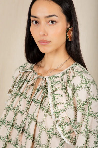 Bonte Florette Top in Clover Woman wearing a floral blouse with a neutral background