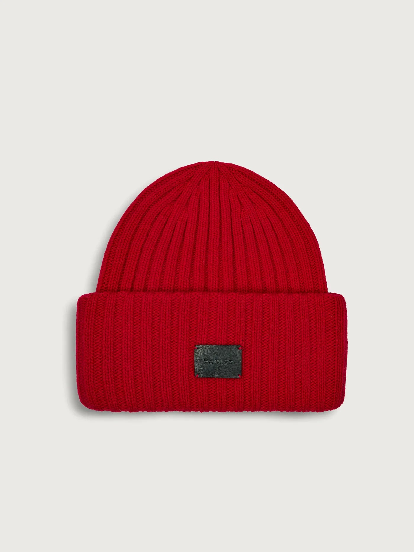 Varley Elva Chunky Rib Beanie in Red Dahlia. Red beanie with a black patch.