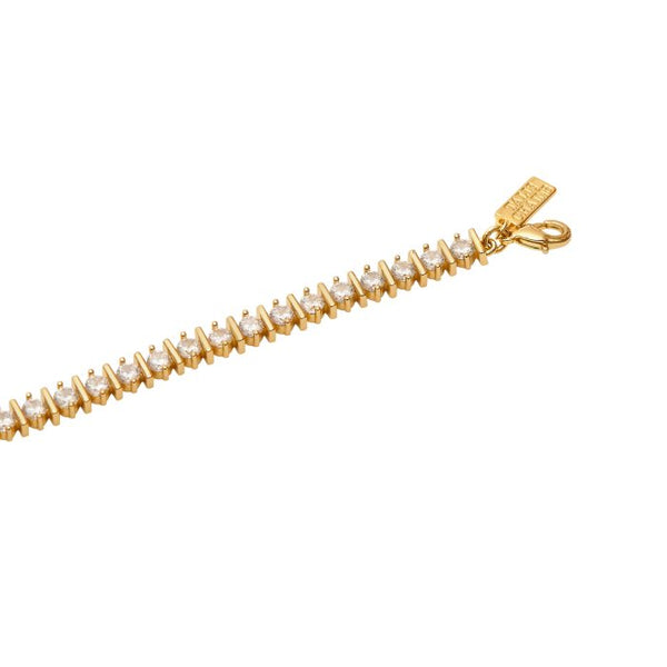 Talis Chains Straight Ridged Tennis Bracelet- Gold Gold bracelet with clear stones on a white background