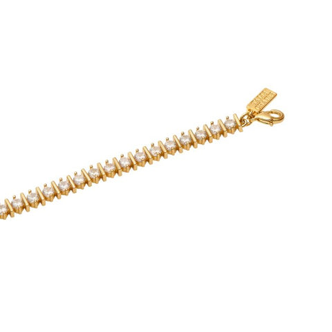 Talis Chains Straight Ridged Tennis Bracelet- Gold Gold bracelet with clear stones on a white background